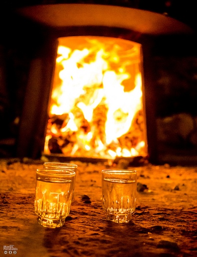 Raki in front of the kazani fire (image by Manos Perakakis)