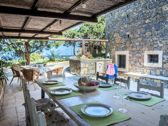 The shady courtyard of the Sitia Windmill will be your second living room with views over the sea